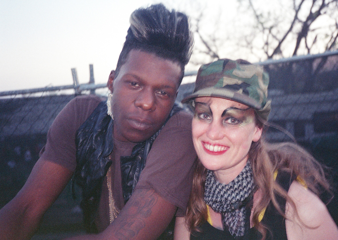 a man and woman with camouflage painted face paint