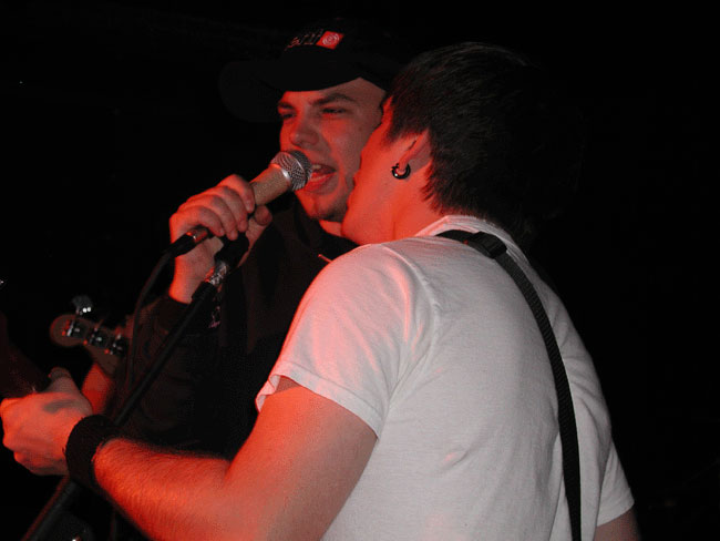 a man is singing into a microphone on stage