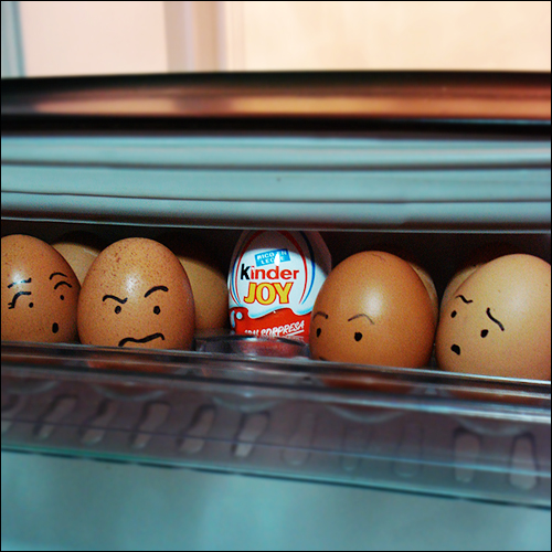 six eggs with faces drawn on them behind a window