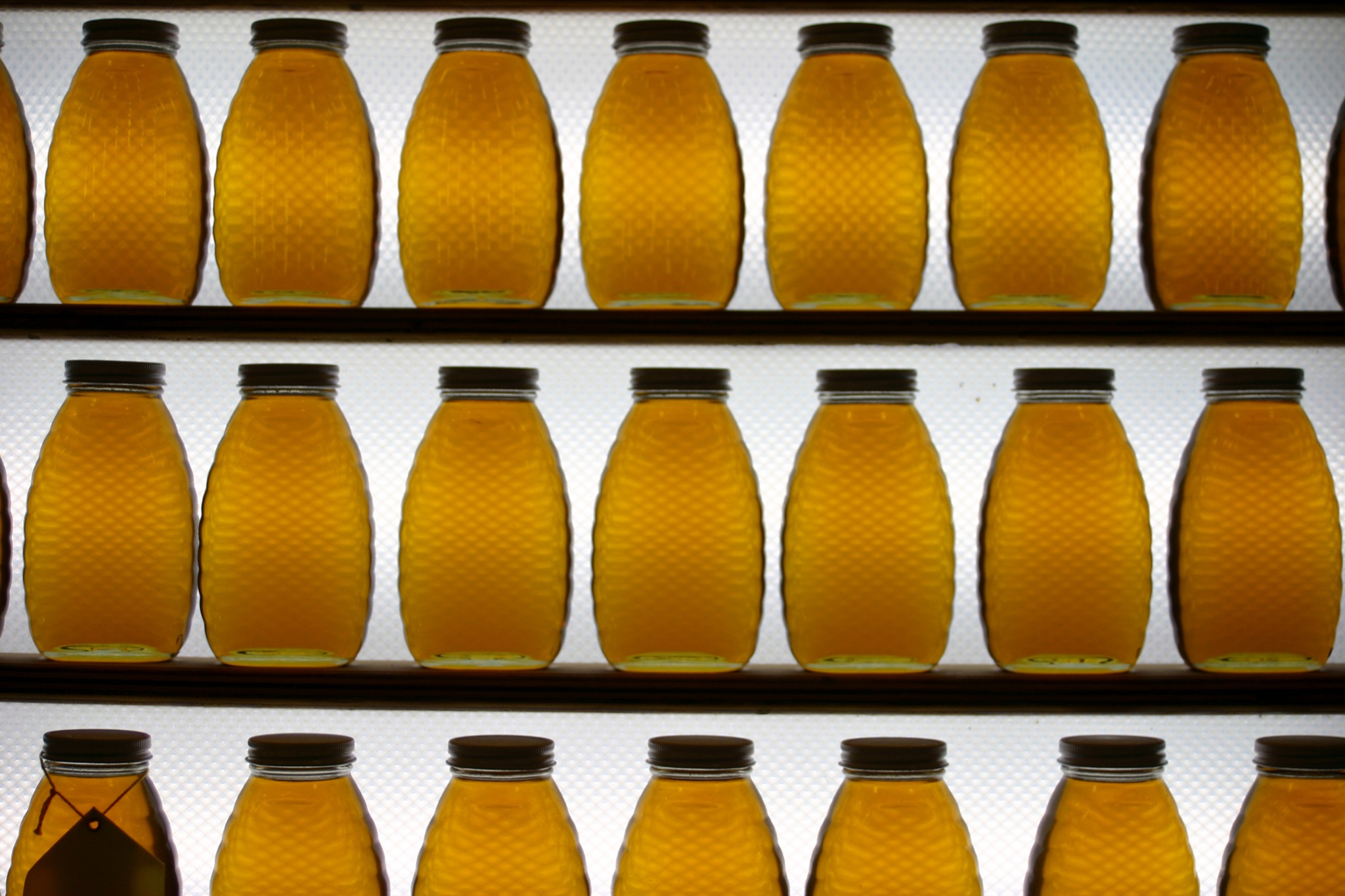 the bottles are lined up in rows with labels on them