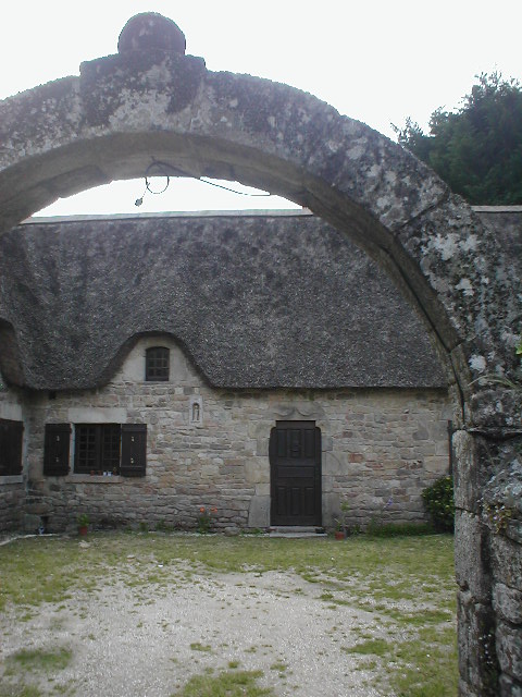 a thatched building with an arched doorway