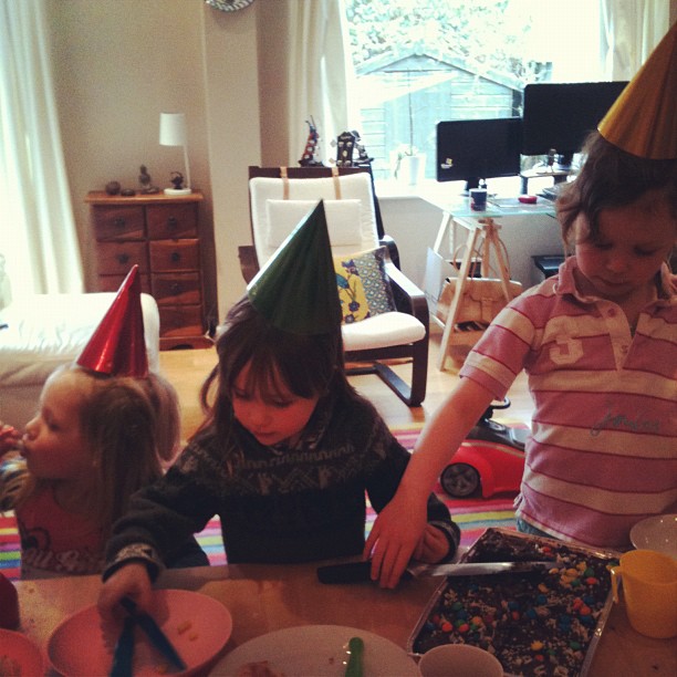 the children are eating their cake at the birthday party