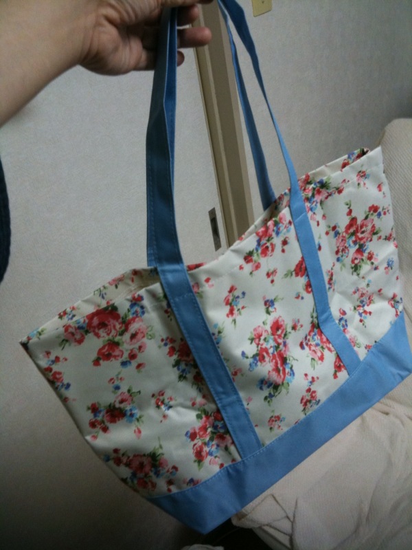 a blue flowered tote bag on a table