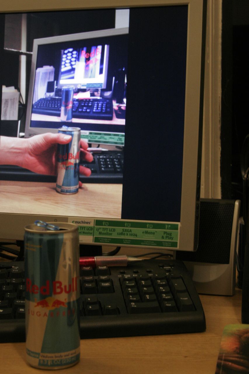 the can of beer is on the computer desk