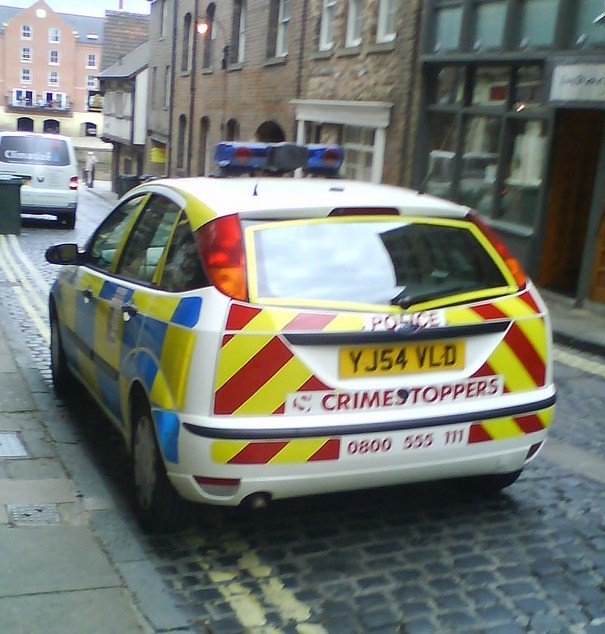 a small police car parked on the side of the street