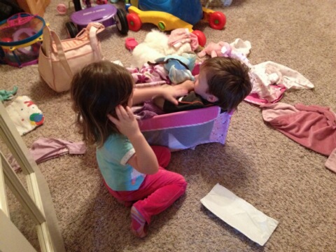 two little s playing in a box full of clothes