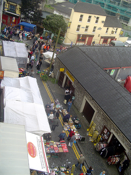 an aerial s of people shopping and eating on the streets of a city