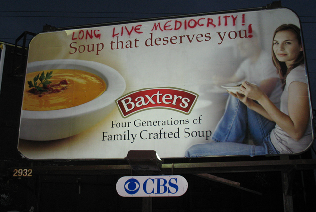 a billboard advertising soup that deserves you on the side of a building