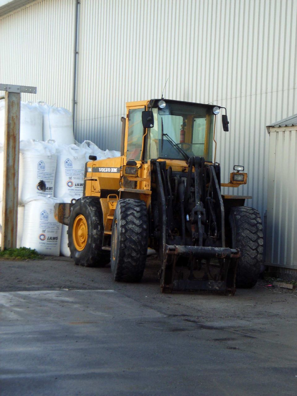 a construction vehicle in front of a warehouse