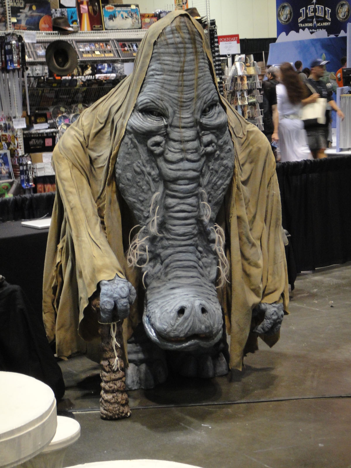 a large head is displayed behind a curtain