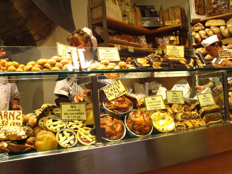 various types of bread displayed in display case