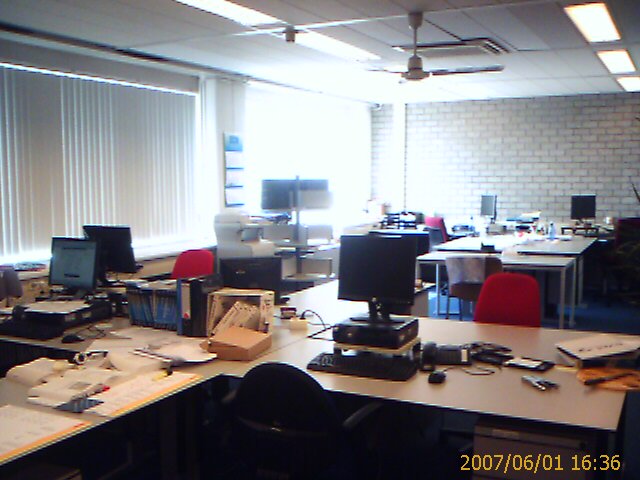 a office with computer equipment and a lamp