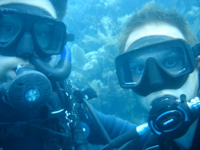 two divers with a diving mask looking at the camera