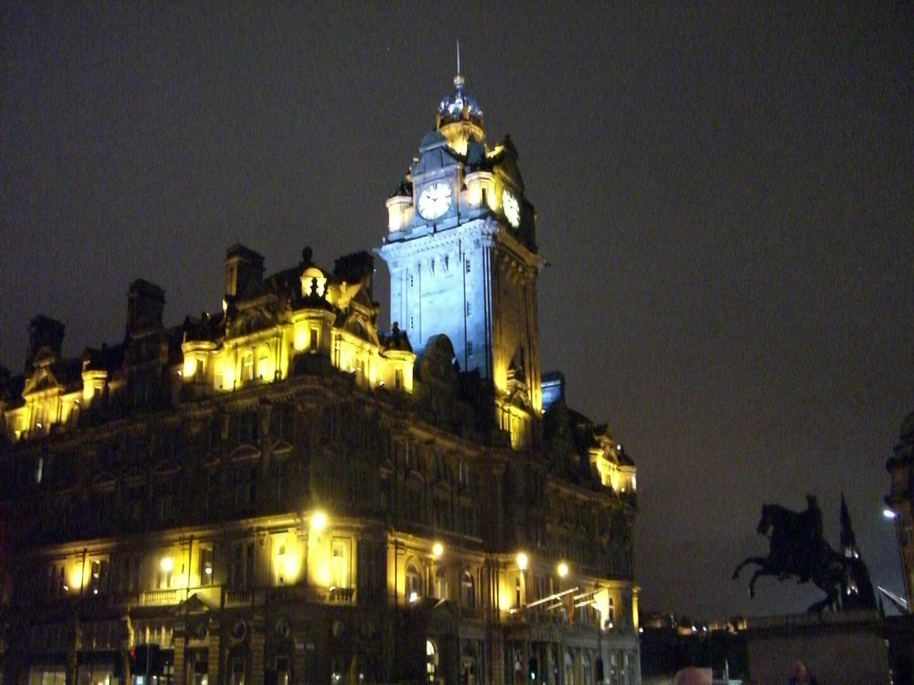 the clock tower is illuminated up at night