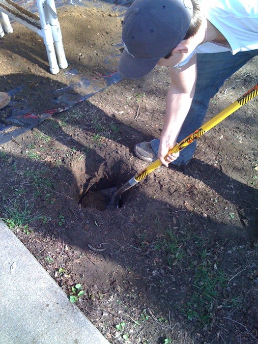a man using a measuring tape to check soil