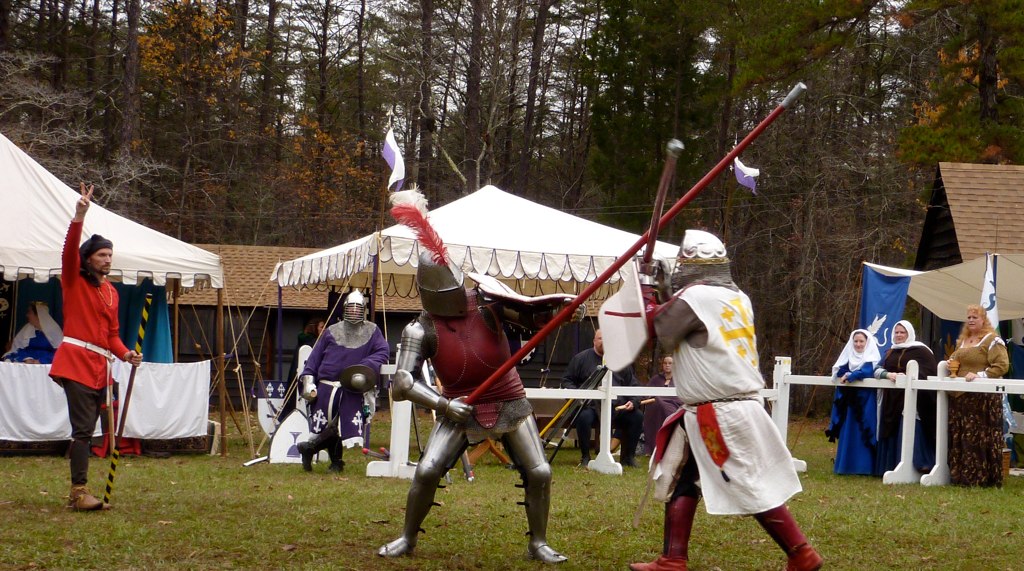 two men dressed up in roman armor and red coats