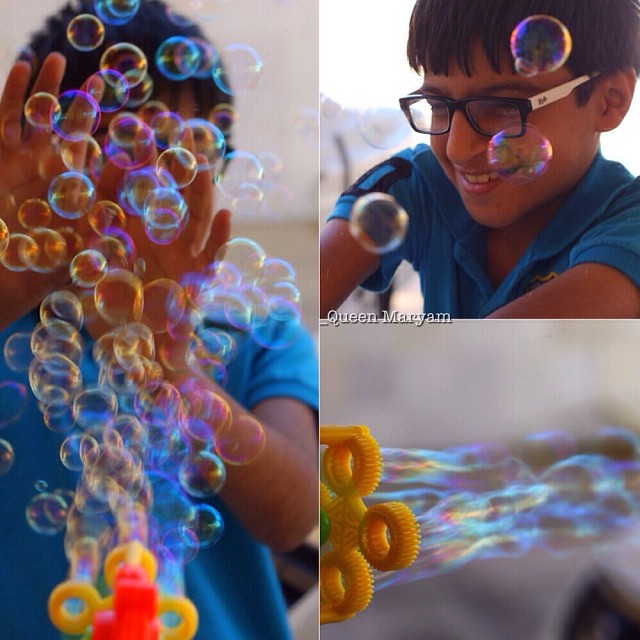 a child is blowing soap bubbles on a table