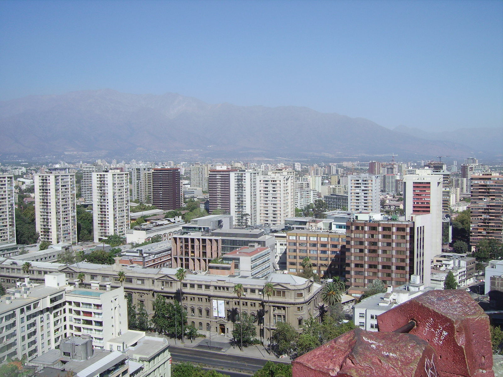 a view of a city that includes buildings and mountains