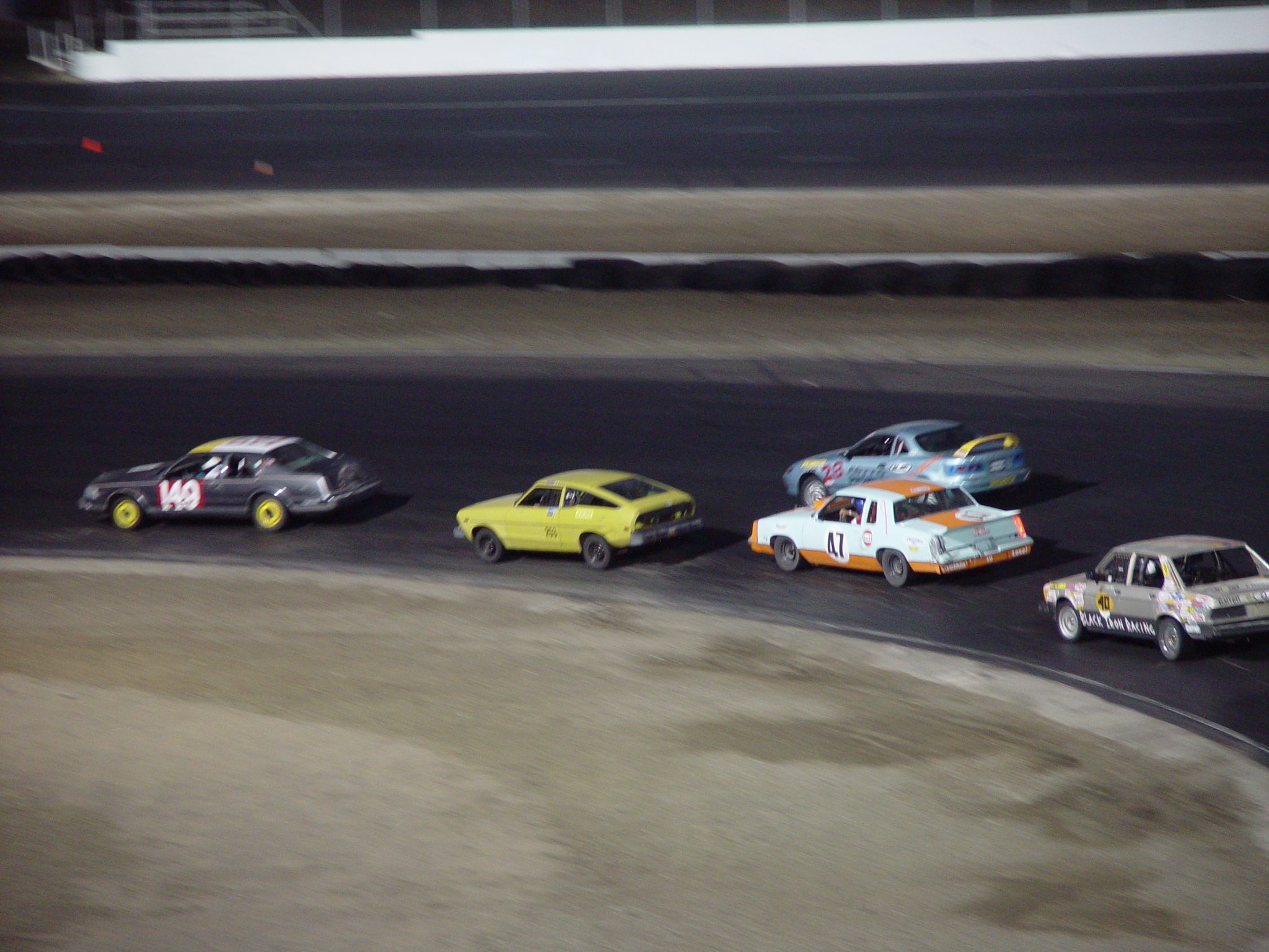 five cars racing through a track at the same time