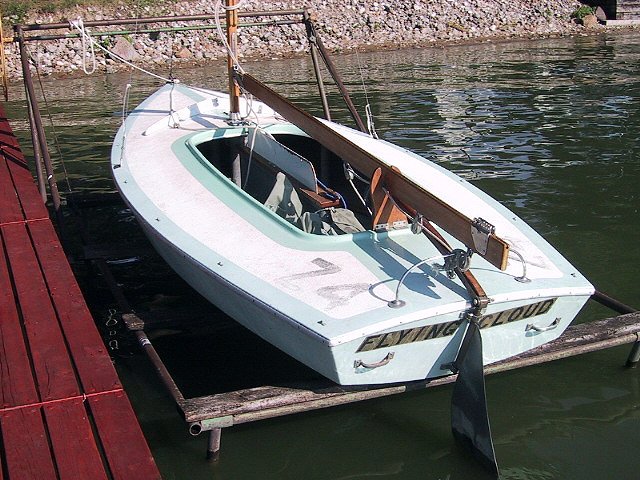 a boat tied up to a dock on water
