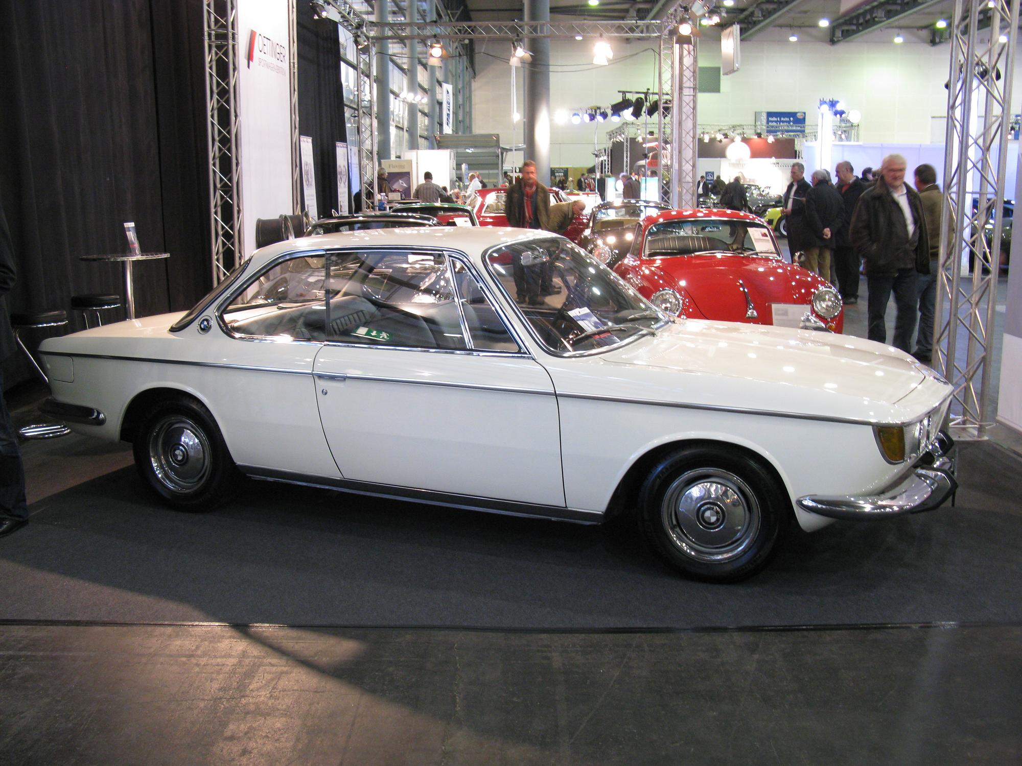 a white car that is on display in a room