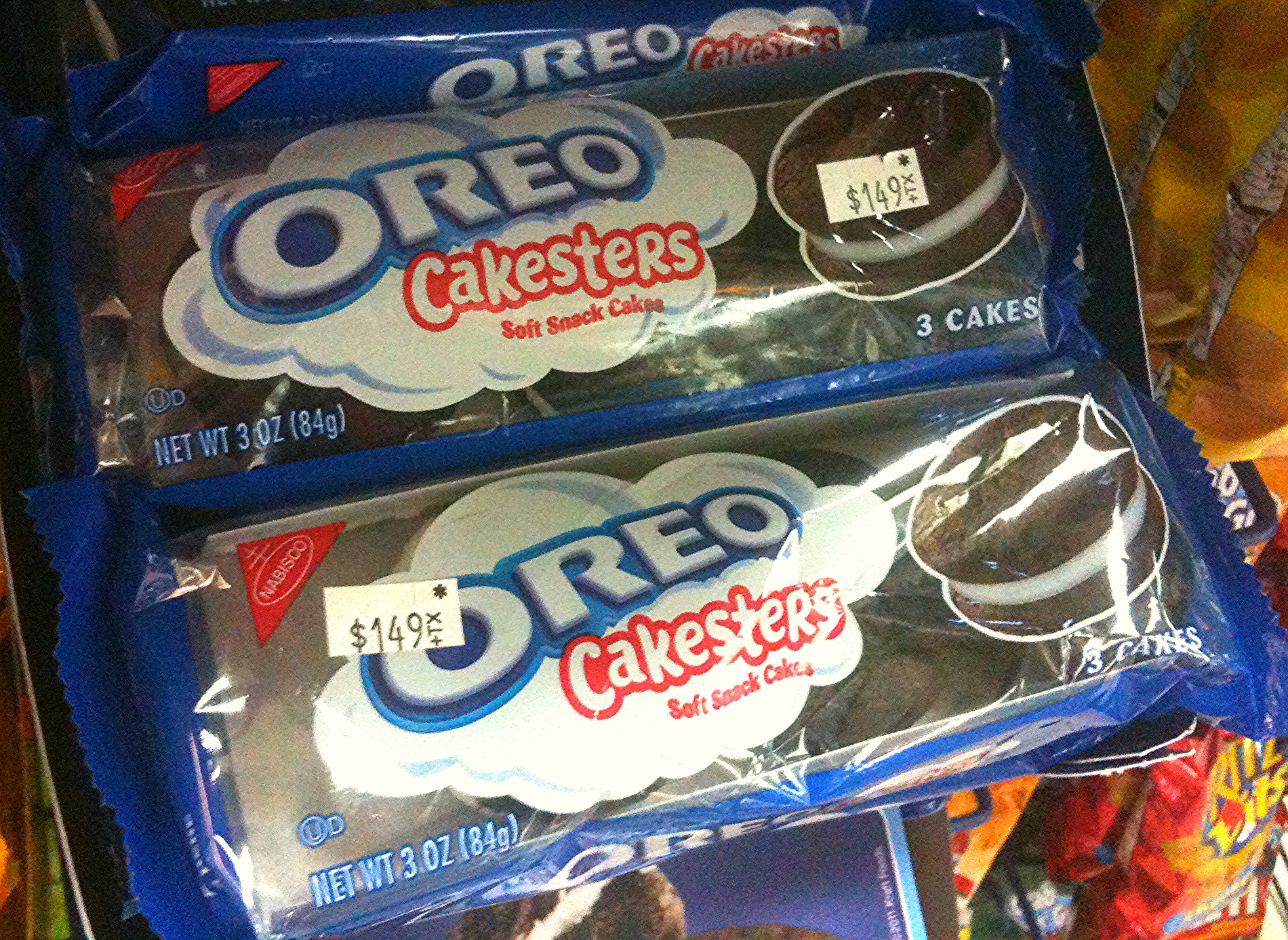 some packages of oreo cookies and cake pops on a shelf