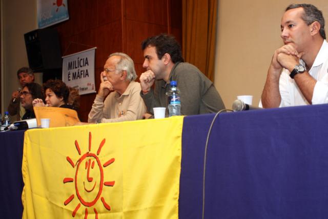 several people sitting at tables at a public meeting