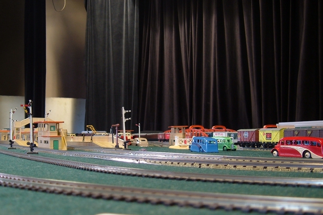 toy trains set on display with black curtain in background