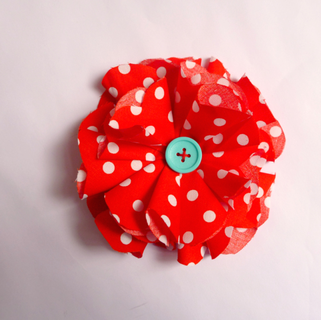 a red flower with white dots on the side