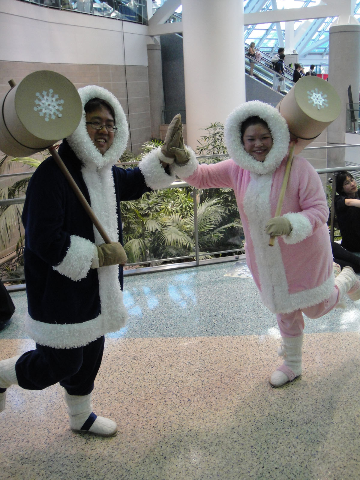 two people dressed in costumes standing in a building