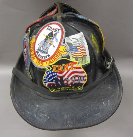 an old black hard hat with patches on it