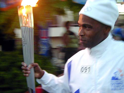 man holding torches in front of a crowd