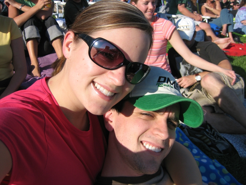 two people wearing hats and sunglasses sitting next to each other