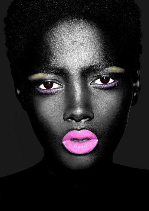 a woman with pink lips and neon makeup