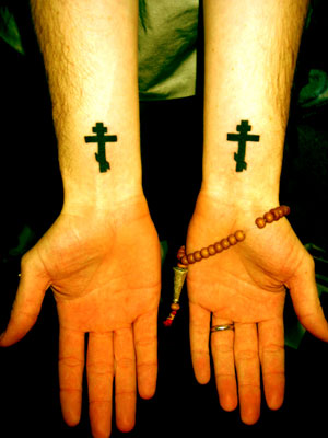 two male armbands with cross tattoos