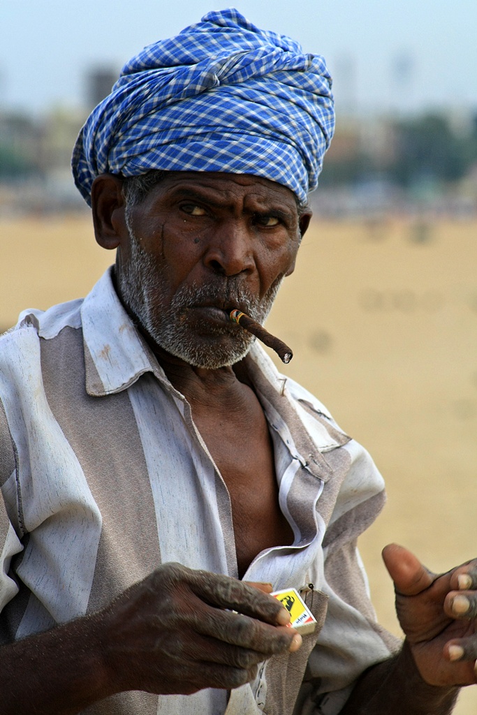 a man smoking and a cigar in the palm