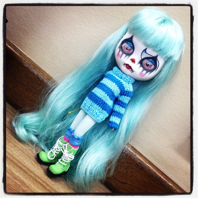 there is an empty doll with blue hair on the stairs