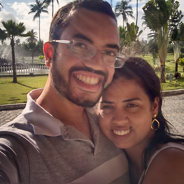 a couple is smiling together while taking a selfie
