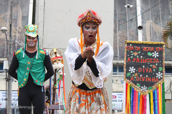 two men dressed in costumes, one holding a rope