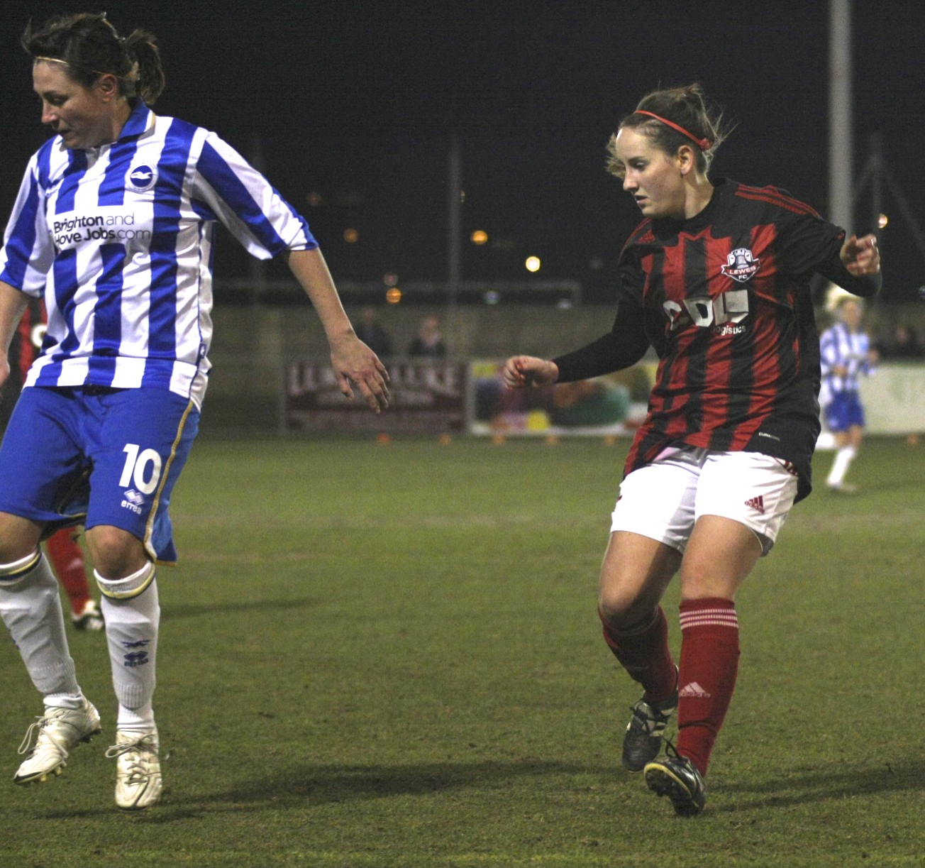 two people are in the field playing soccer