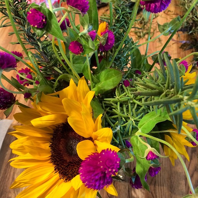 a vase of flowers on top of a wooden table