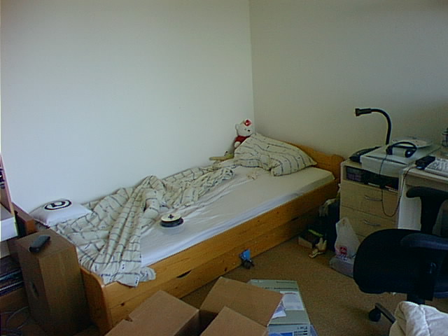 a room that has boxes around the bed