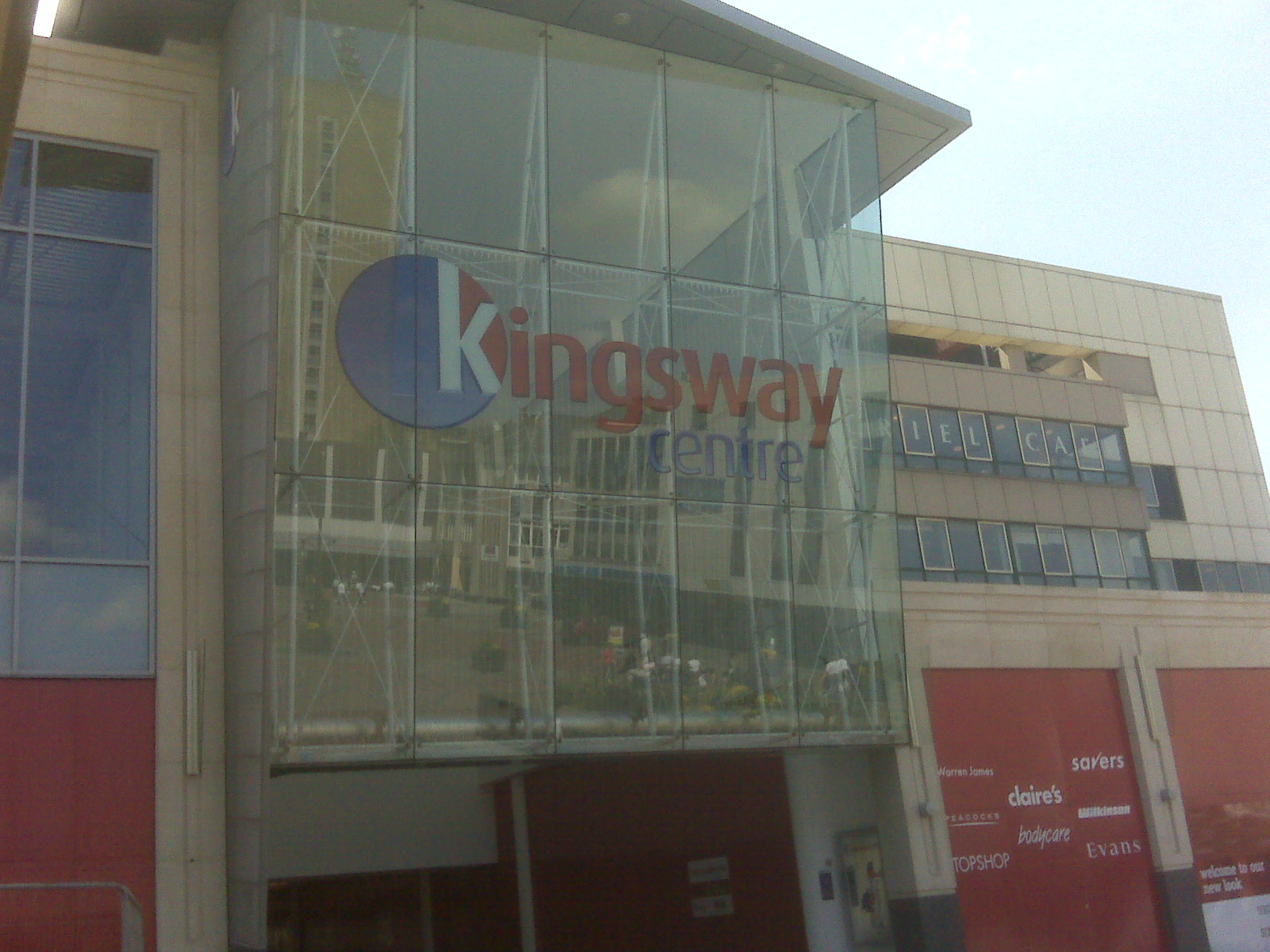 the logo of kingsway shopping in front of a large glass building