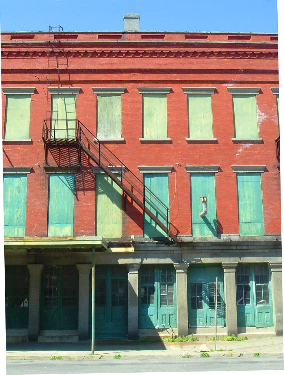 a building has blue shutters and red brick