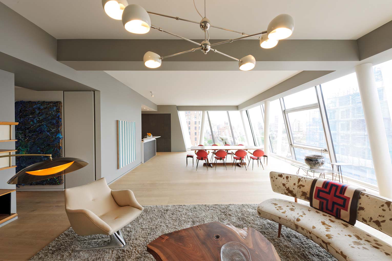 a living room filled with furniture and a wooden table