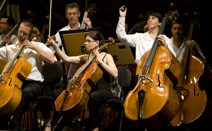 an orchestra with several male and female cell phones