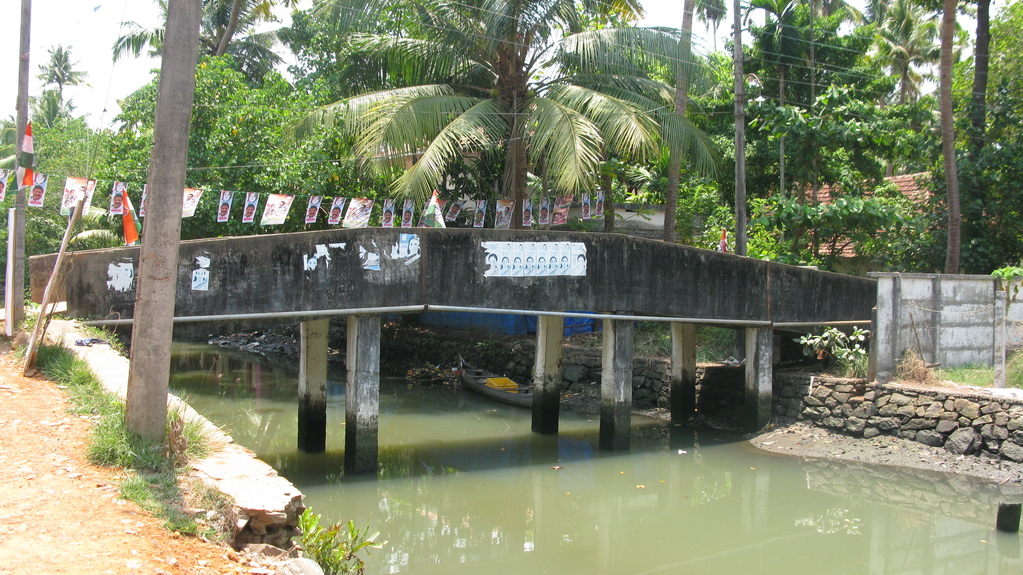 some boats floating in the water and a bridge is over