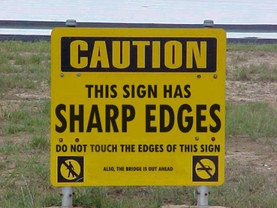 caution sign that says this sign has sharp edges