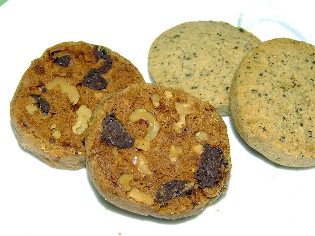 three cookies are arranged on a white surface