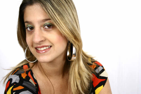 a beautiful woman smiling and wearing big hoop earrings